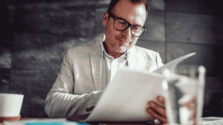 office-man-reviewing-documents-report